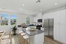 kitchen with large windows and white cabinets