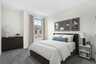 carpet with queen bedroom and drawers