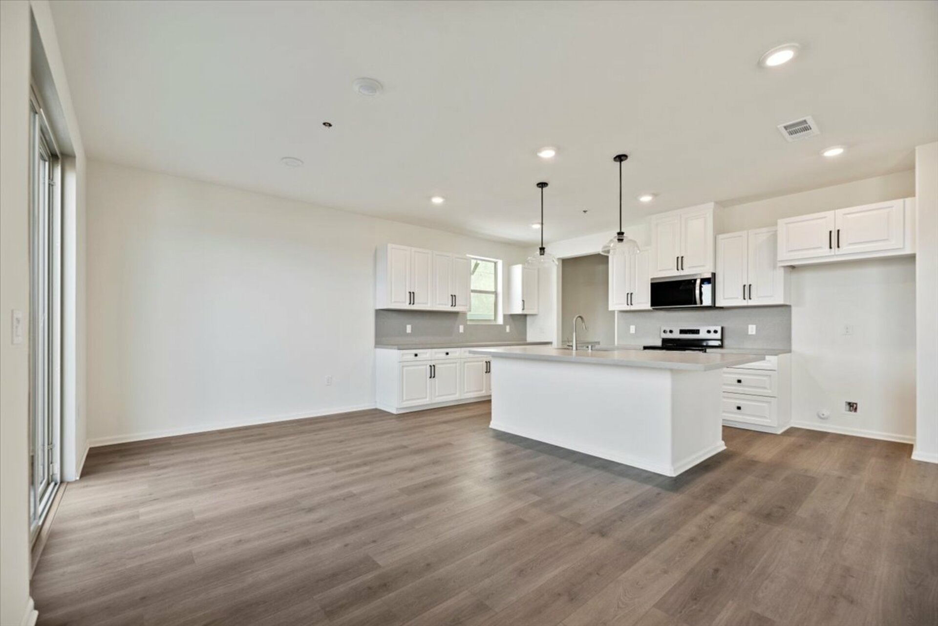dining room with the kitchen in the background with a large island