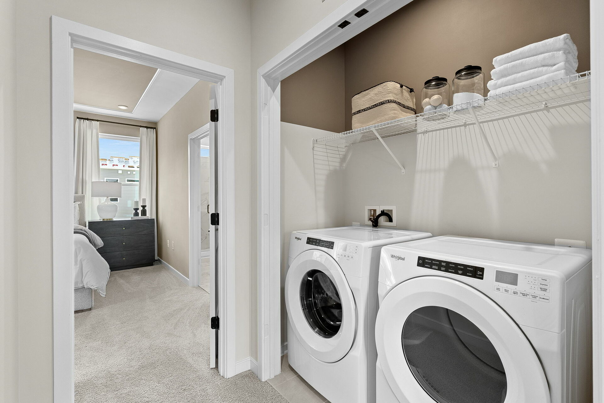 upstairs laundry with two white washer and dryers