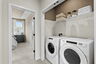 upstairs laundry with two white washer and dryers