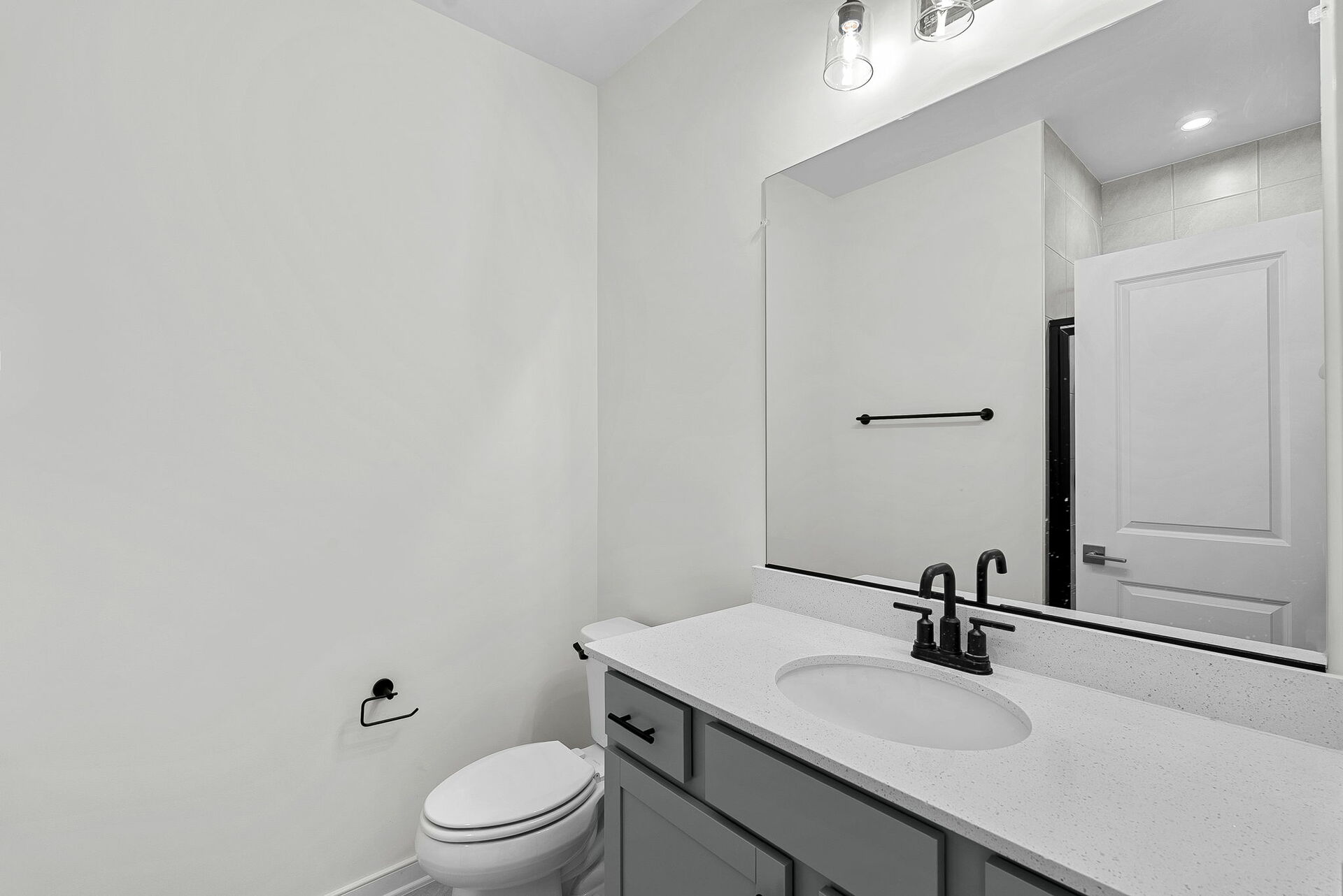 vanity sink and mirrors and toilet