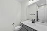 vanity sink and mirrors and toilet