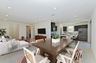 dining room featuring a brown dining table with 6 white dining chairs