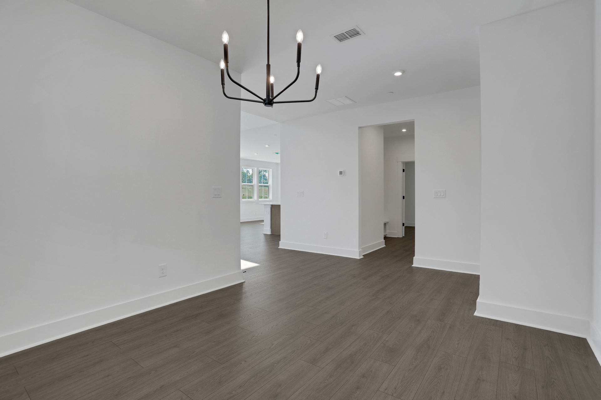 dining room with hard surface flooring and matte black light fixture