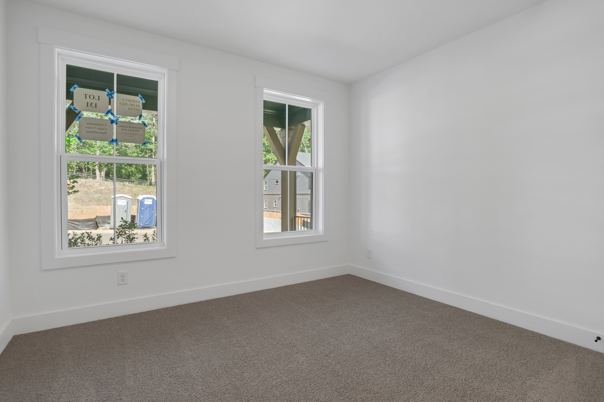 bedroom on main floor with windows and carpet