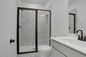 secondary bathroom with gray cabinets and tile flooring