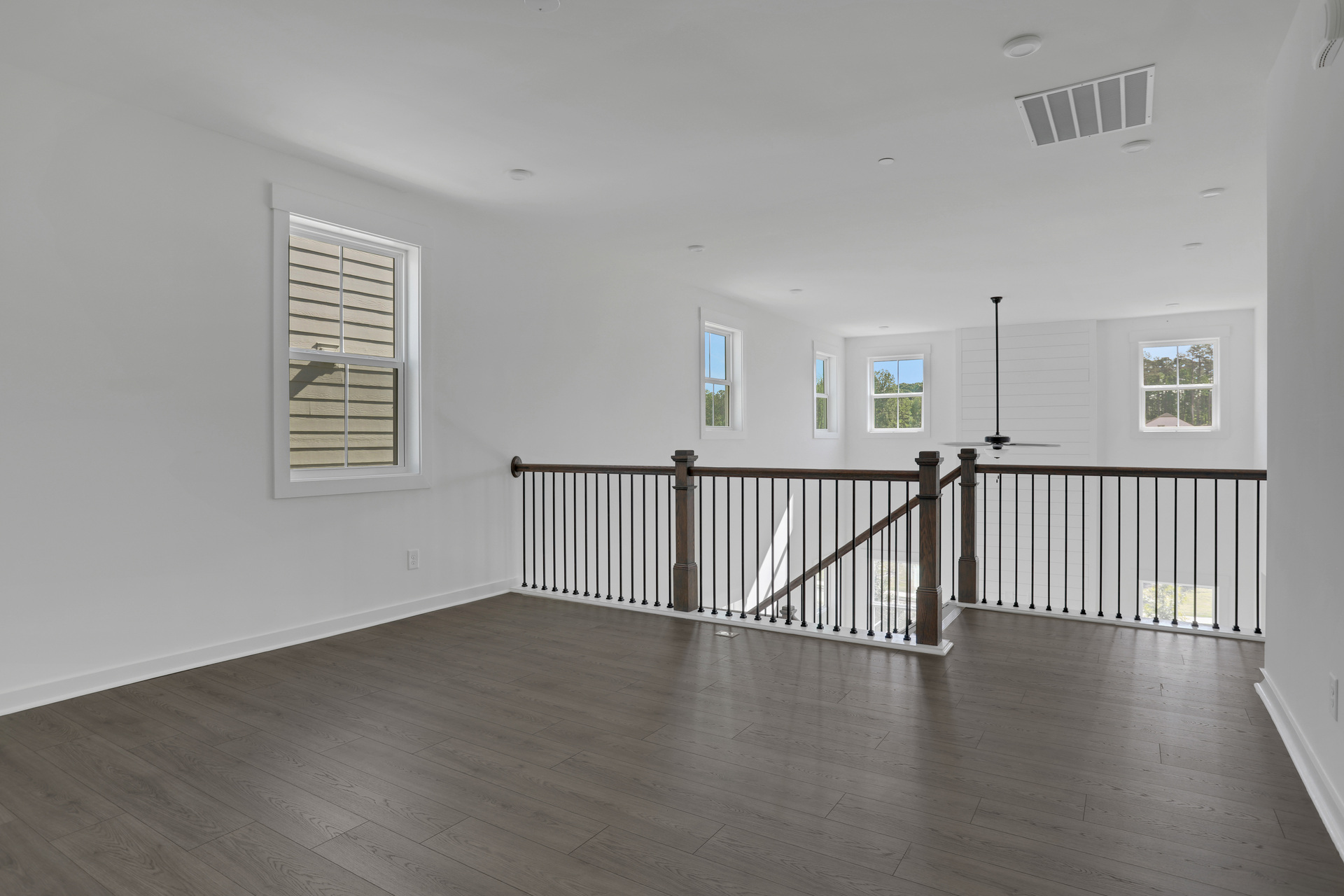 loft overlooking 2-story great room with hard surface floors