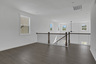 loft overlooking 2-story great room with hard surface floors