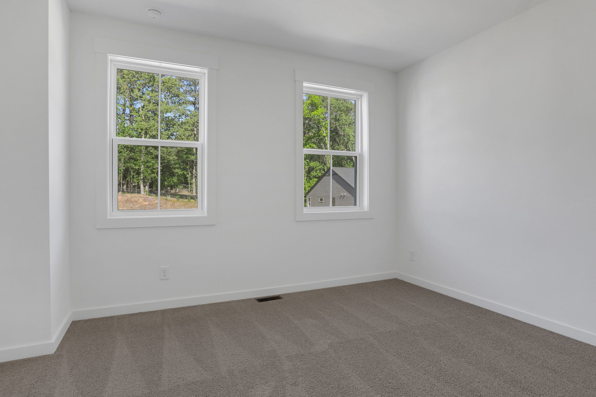 bedroom with windows and carpet