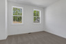 bedroom with windows and carpet