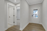 foyer with hard surface flooring and hallway for secondary bedrooms