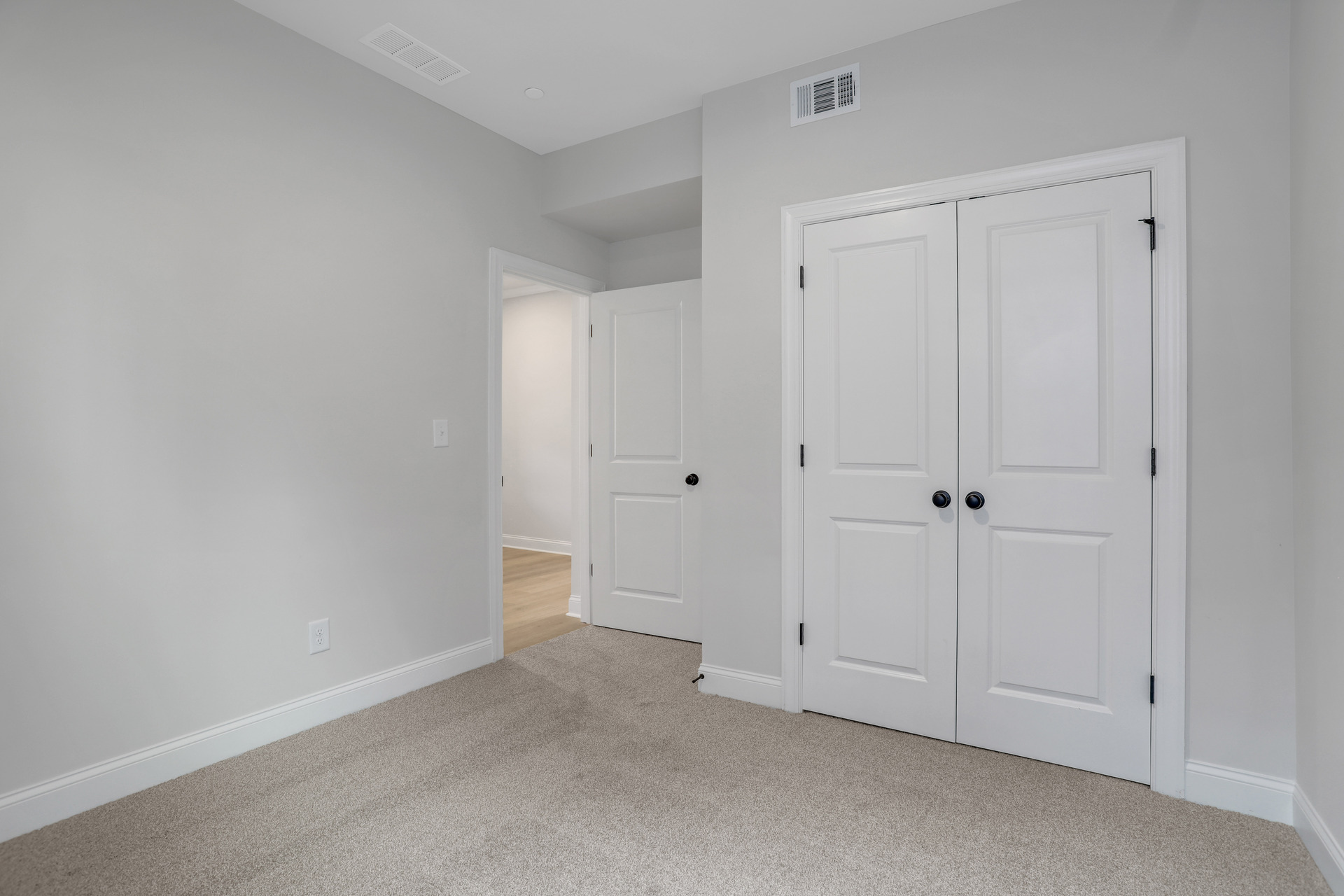 bedroom with windows and carpets