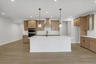 kitchen with wood-finish cabinets and quartz counters
