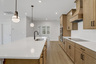 kitchen with wood-finish cabinets and quartz counters