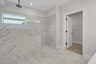 primary bathroom with large walk-in shower and tile floors