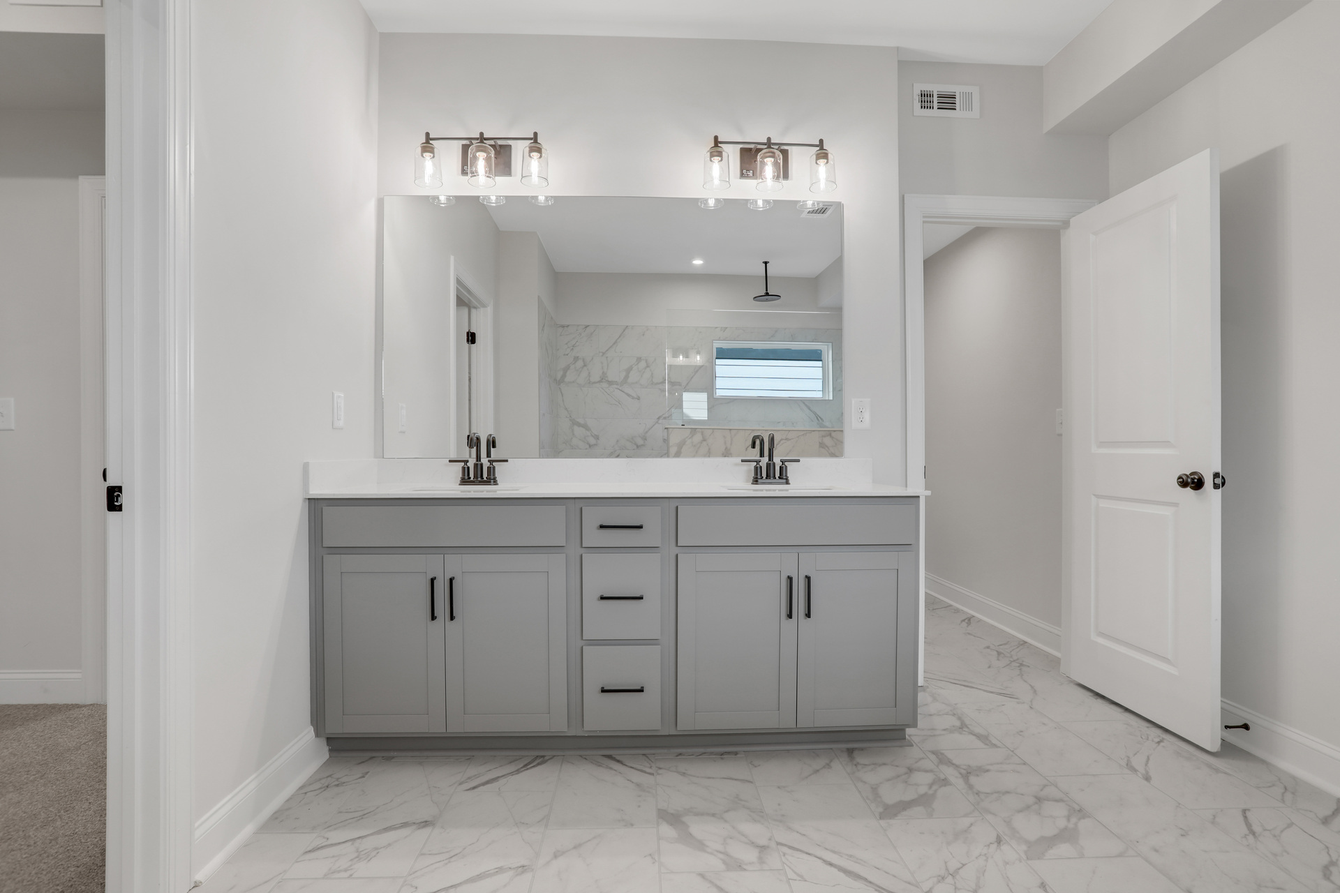 primary bathroom with gray cabinets and tile flooring