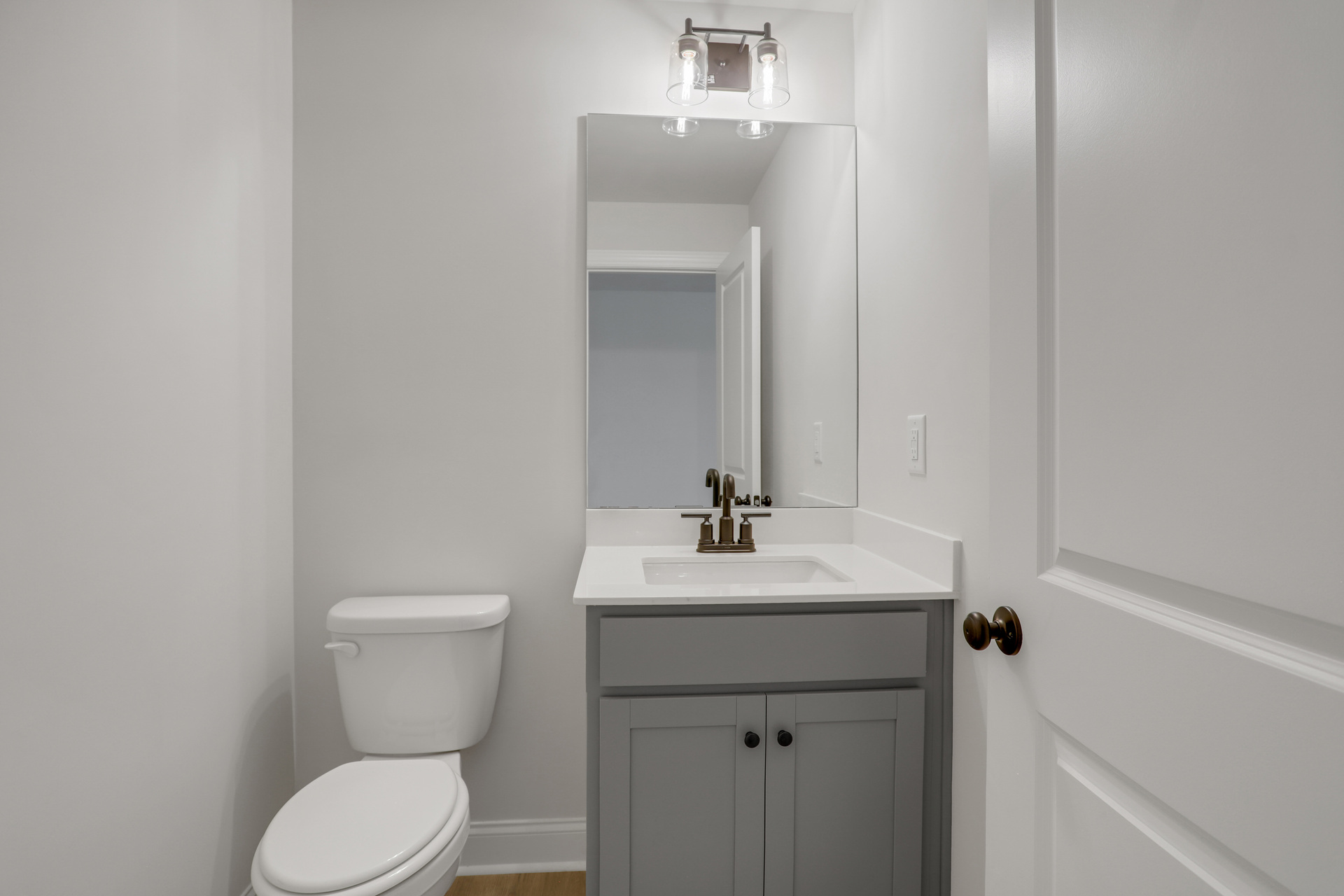 powder bathroom with gray cabinets