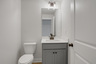 powder bathroom with gray cabinets