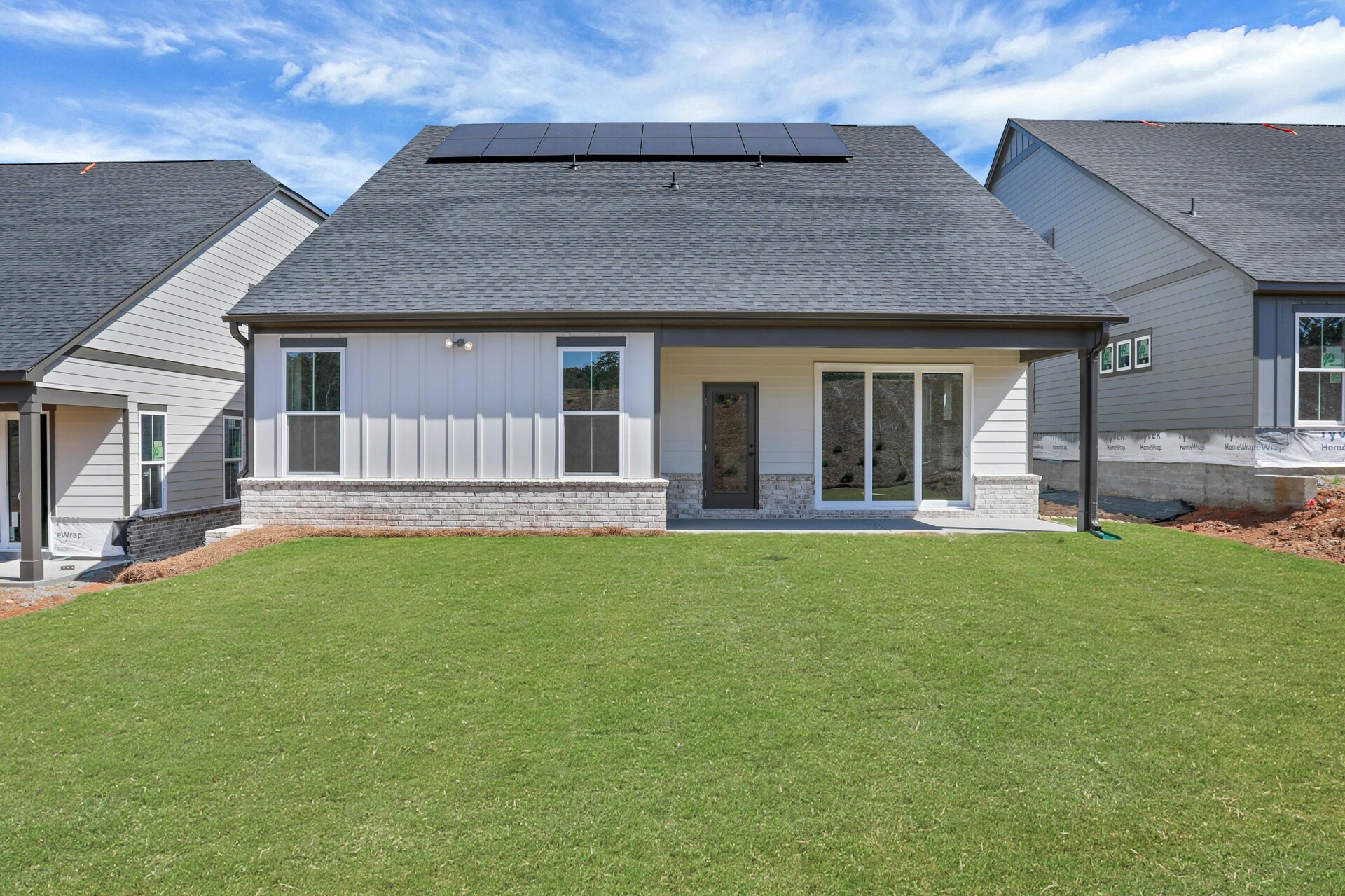 backyard with covered patio and lush green grass