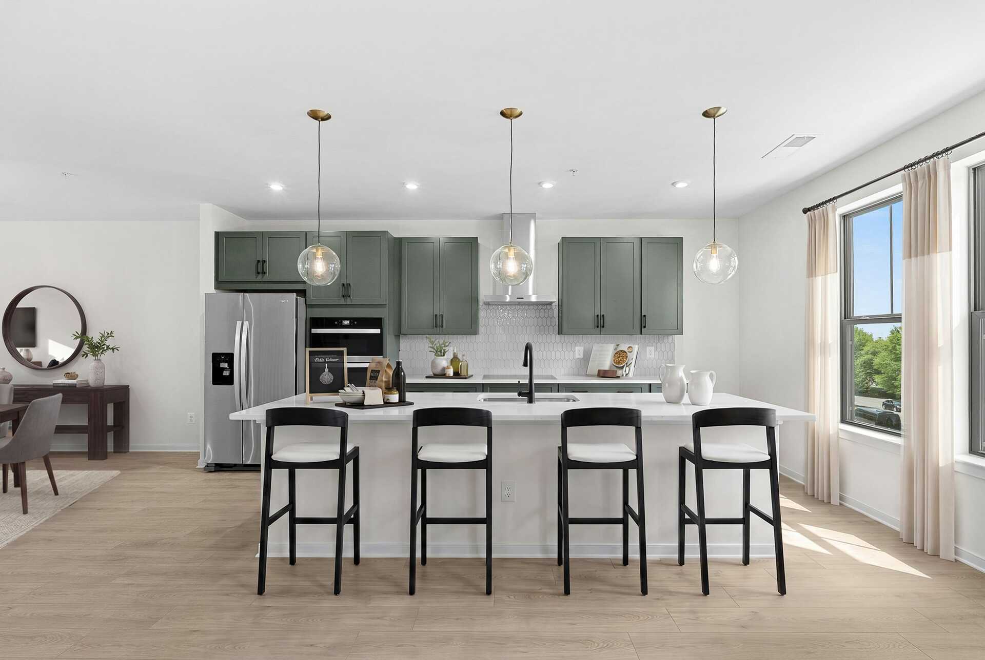 kitchen island with chairs and pendant lighting
