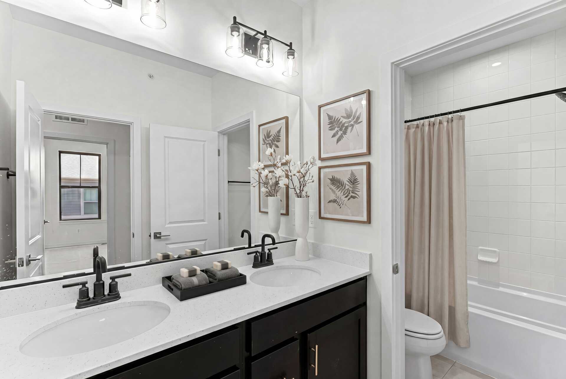 vanity dual sink and mirrors and toilet