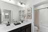 vanity dual sink and mirrors and toilet