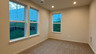 recreation room with windows and carpet