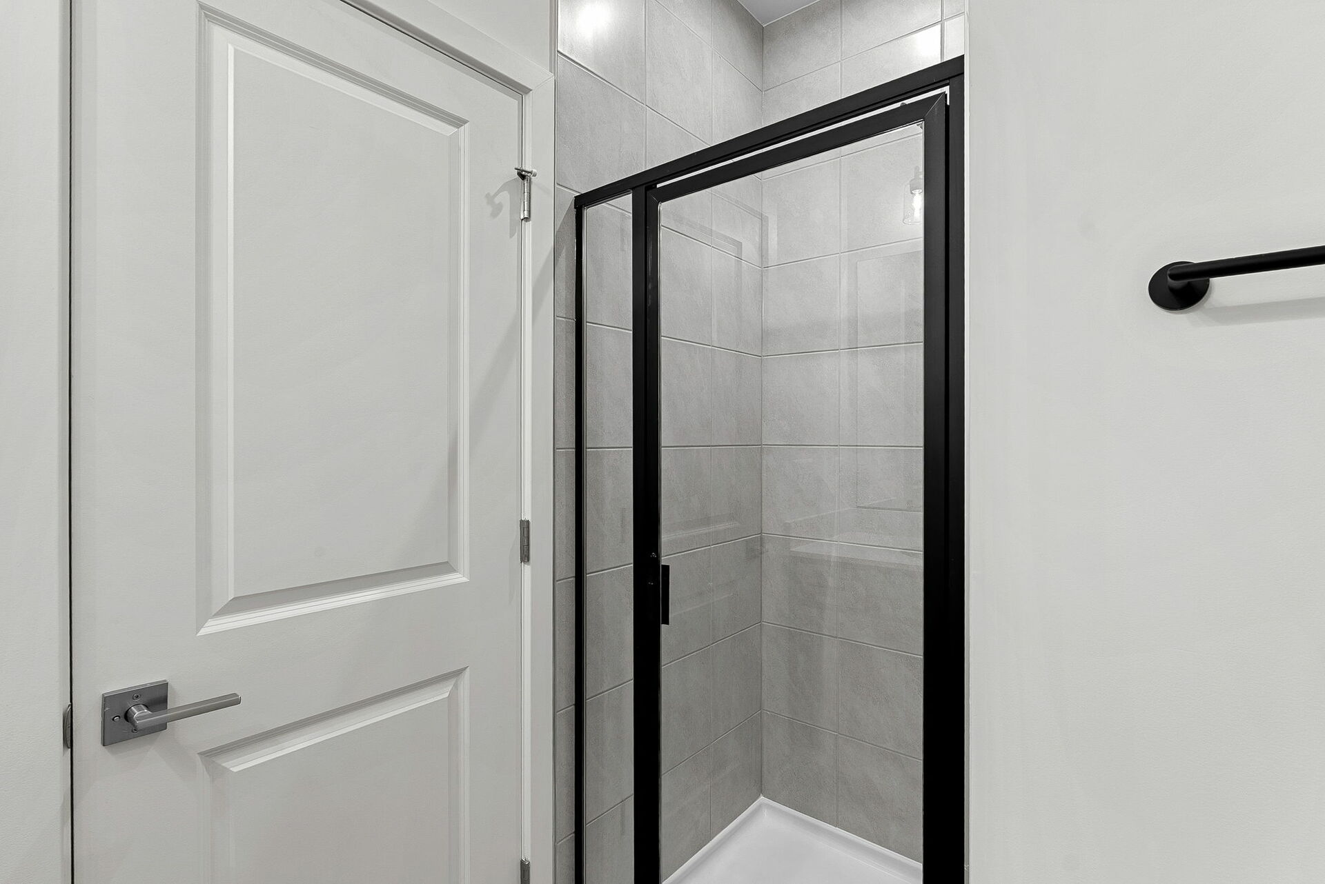 walk in shower and tiles and cabinets