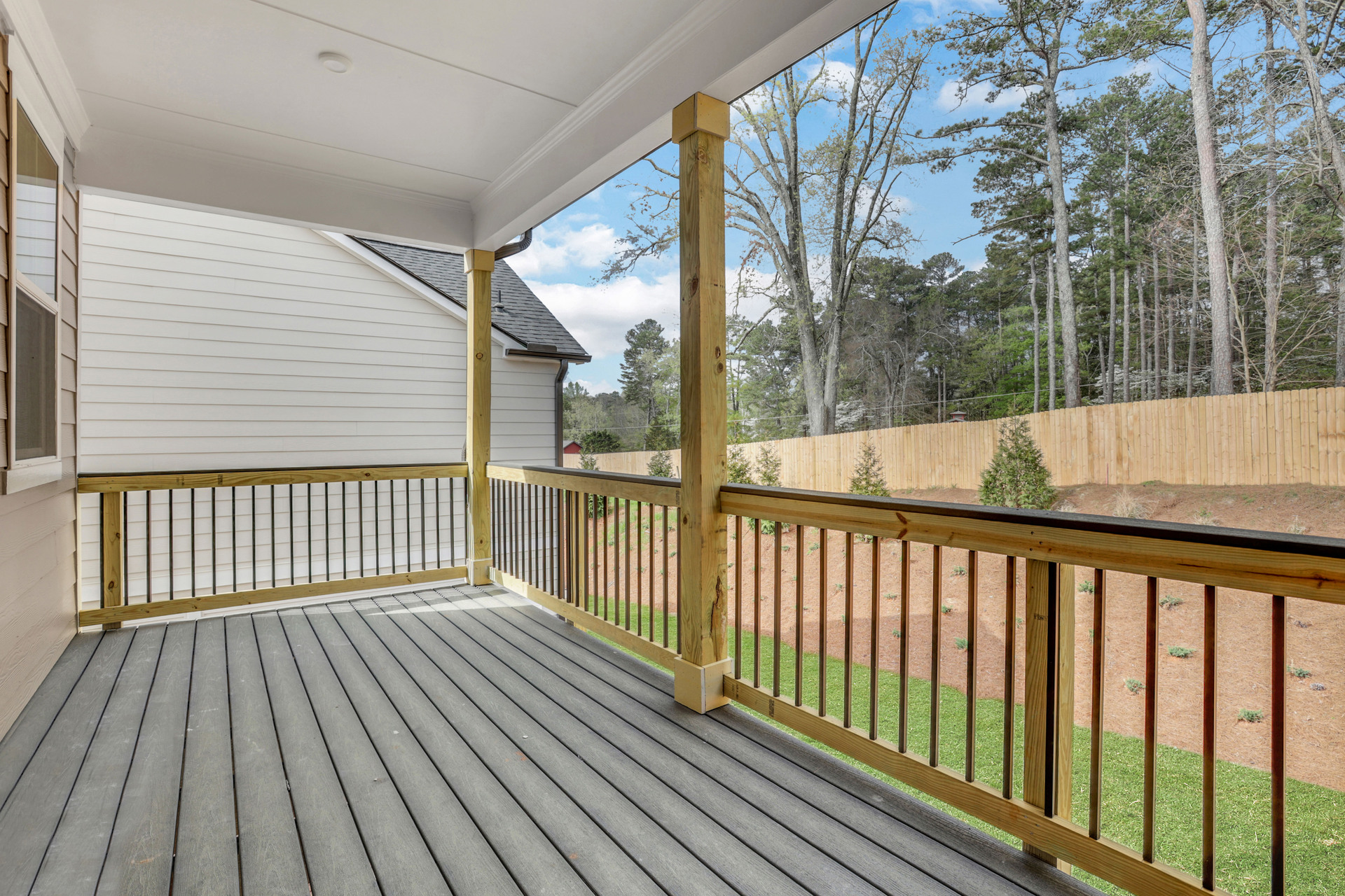 covered balcony off the primary bedroom with view of backyard