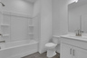 bathroom with white tile floors and bath tub