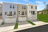 back of the home with two car garage and driveway