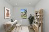 study with neutral floors and large window