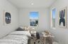 bedroom with neutral carpet and large windows