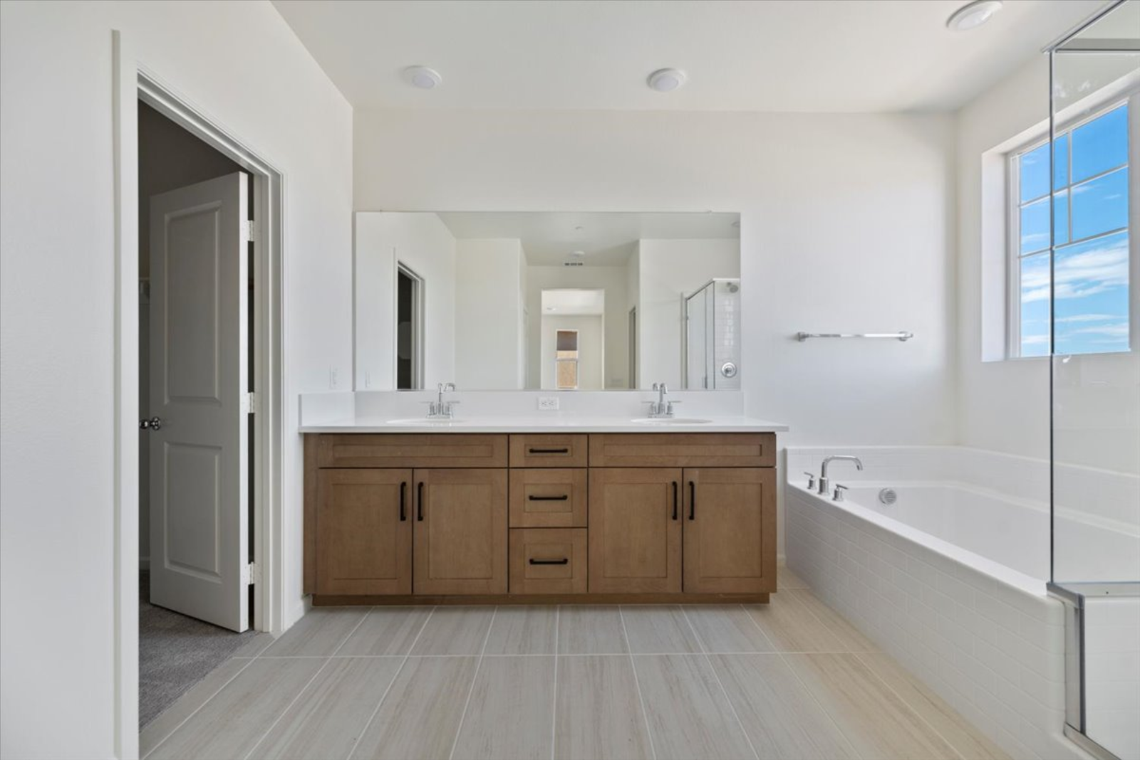 primary bathroom with a soaking tub and walk-in shower and a dual sink countertop next to it