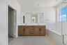 primary bathroom with a soaking tub and walk-in shower and a dual sink countertop next to it