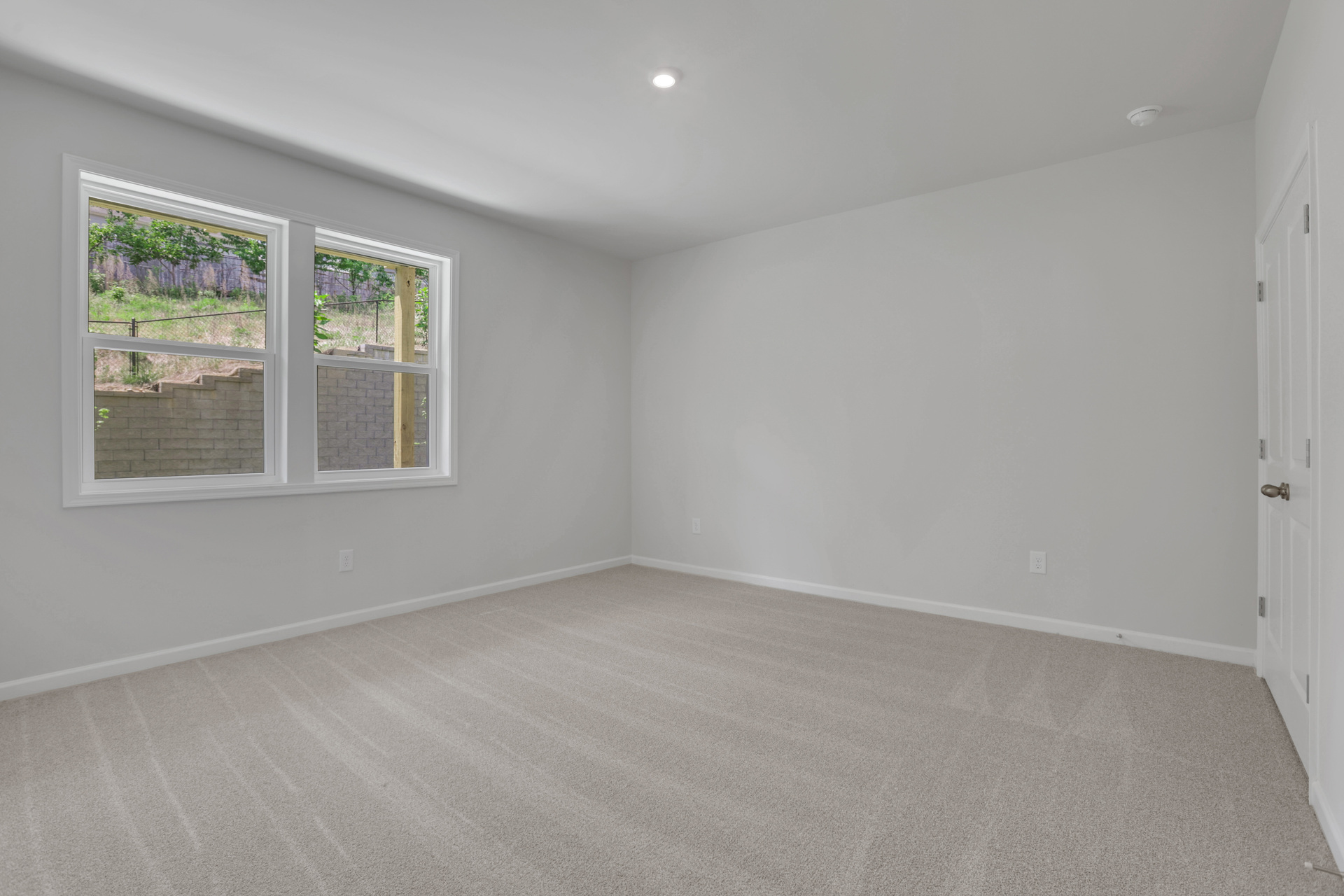 bedroom with windows and carpet