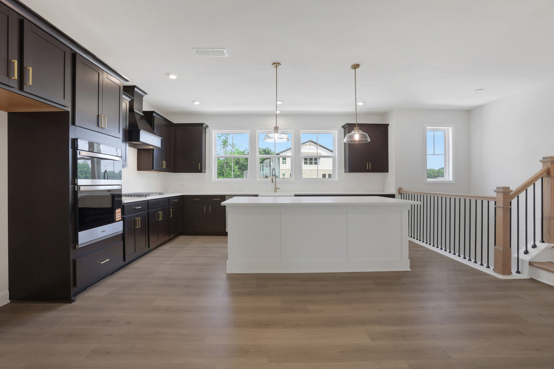 kitchen with dark cabinets and quartz counters