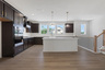 kitchen with dark cabinets and quartz counters