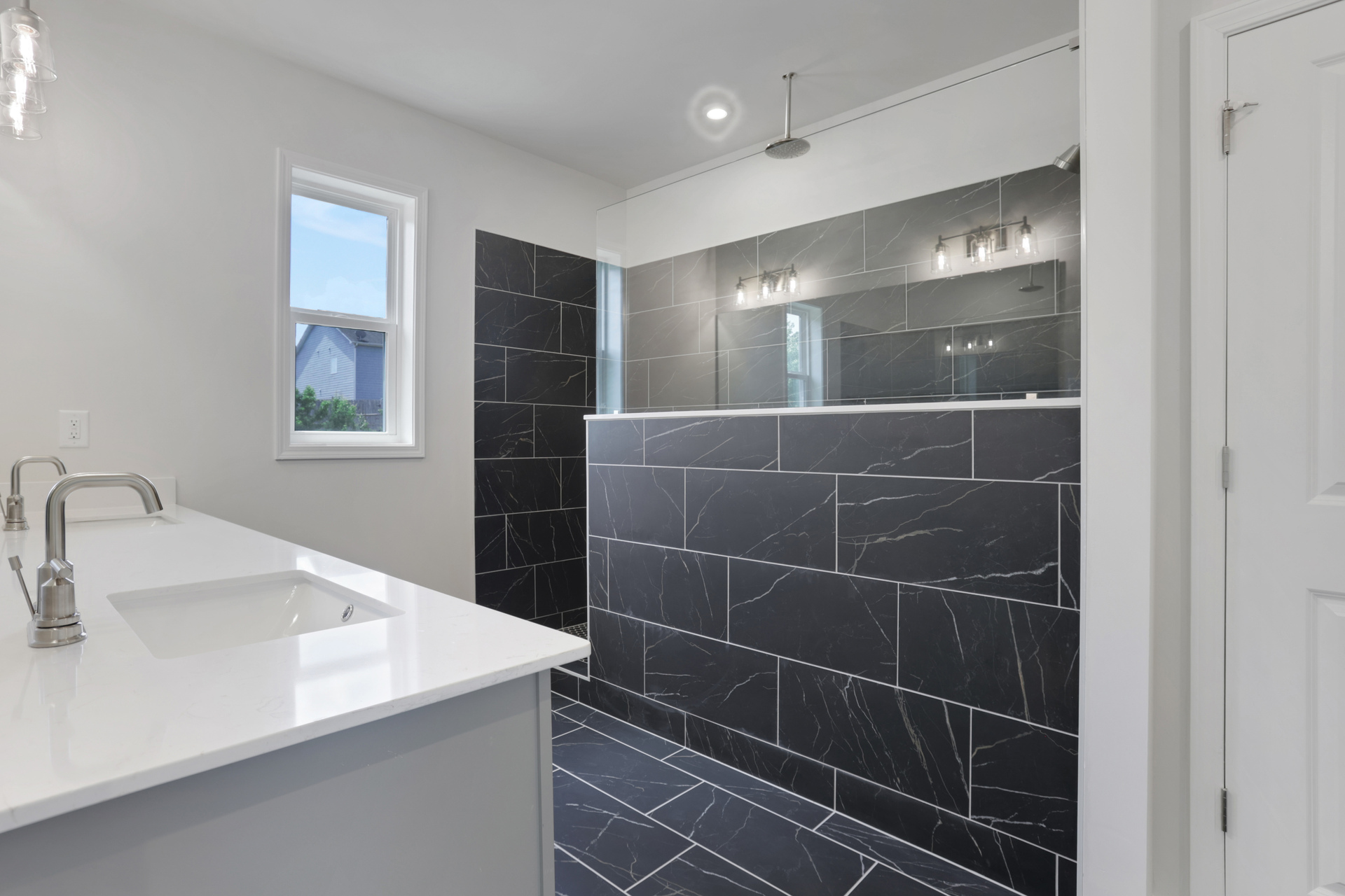 primary bathroom with large walk-in shower and tile flooring