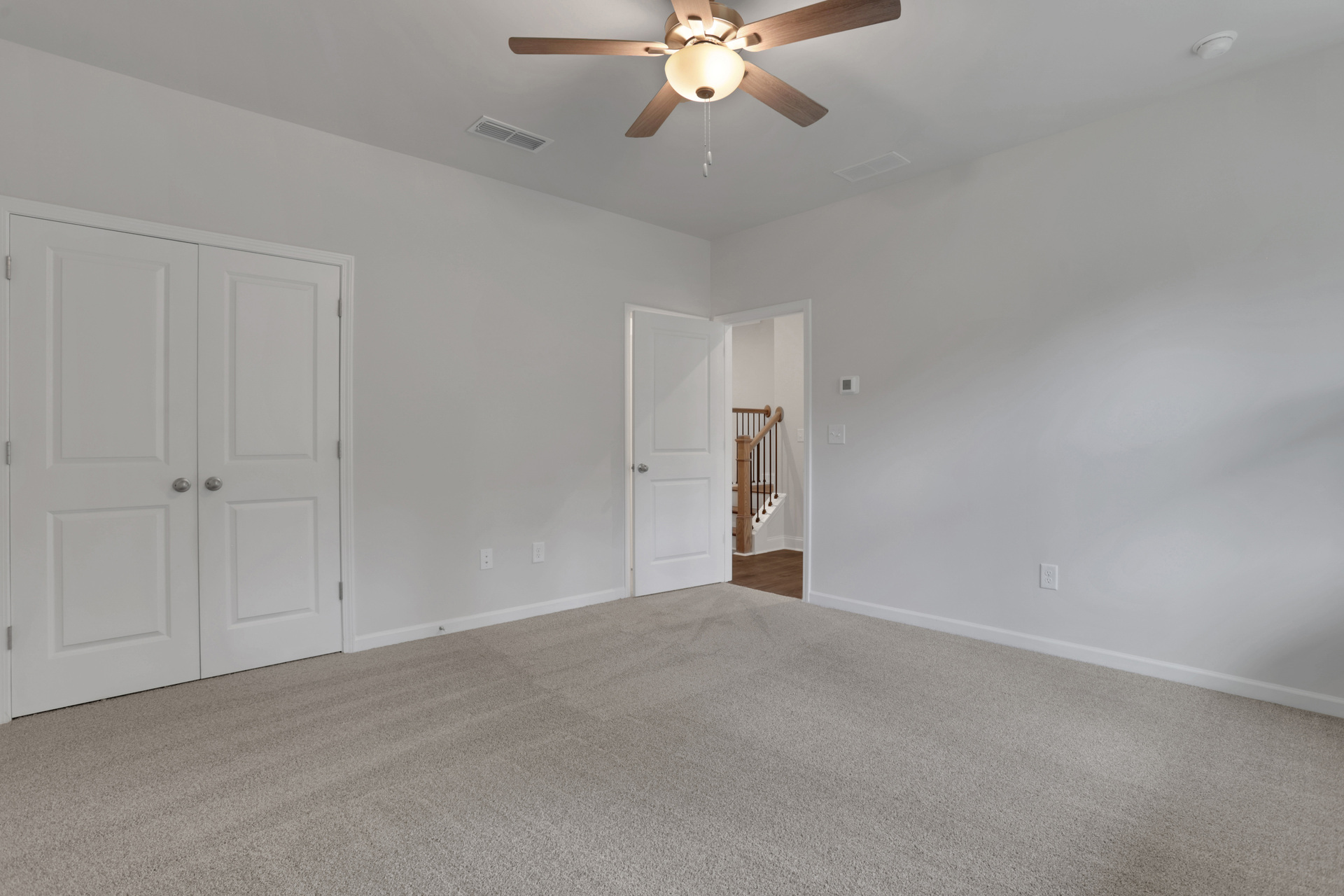 bedroom with en-suite bath and carpet