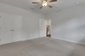 bedroom with en-suite bath and carpet