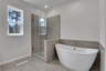 primary bathroom with separate shower and soaker tub