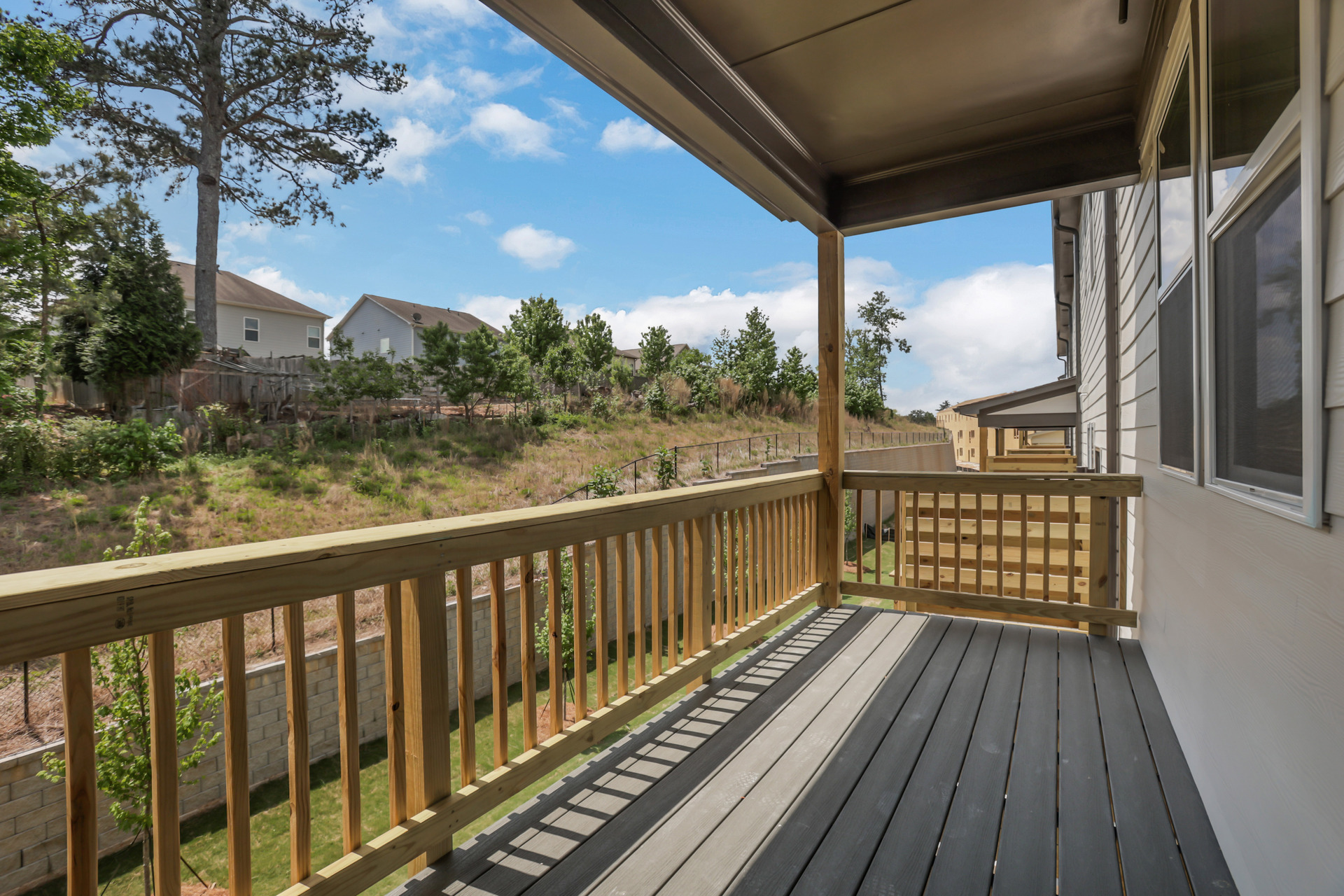 covered deck overlooking backyard located off the great room