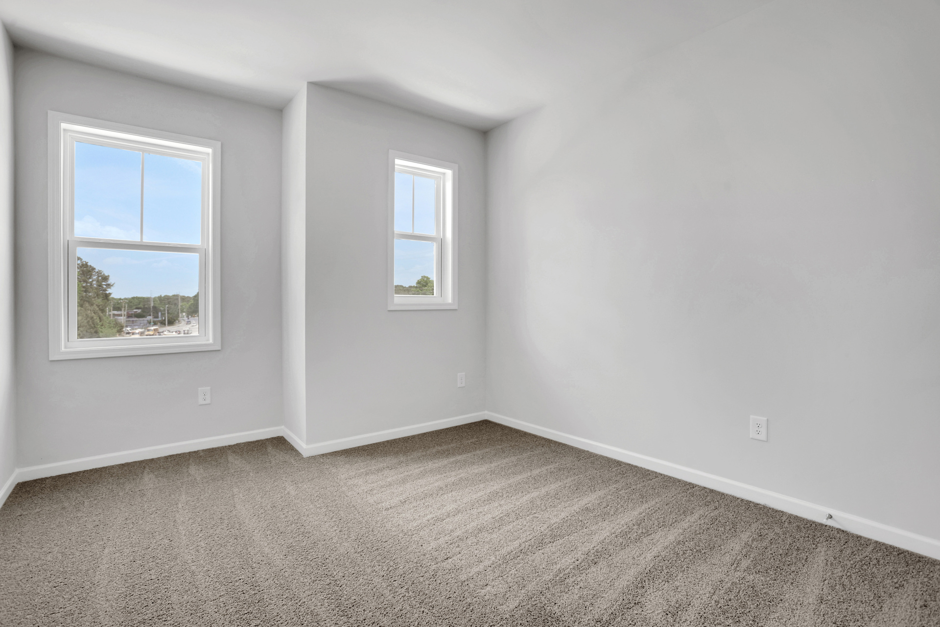 bedroom with windows and carpet