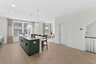 kitchen island with green cabinets and pendant lighting