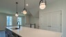 large white kitchen island and pendant lighting