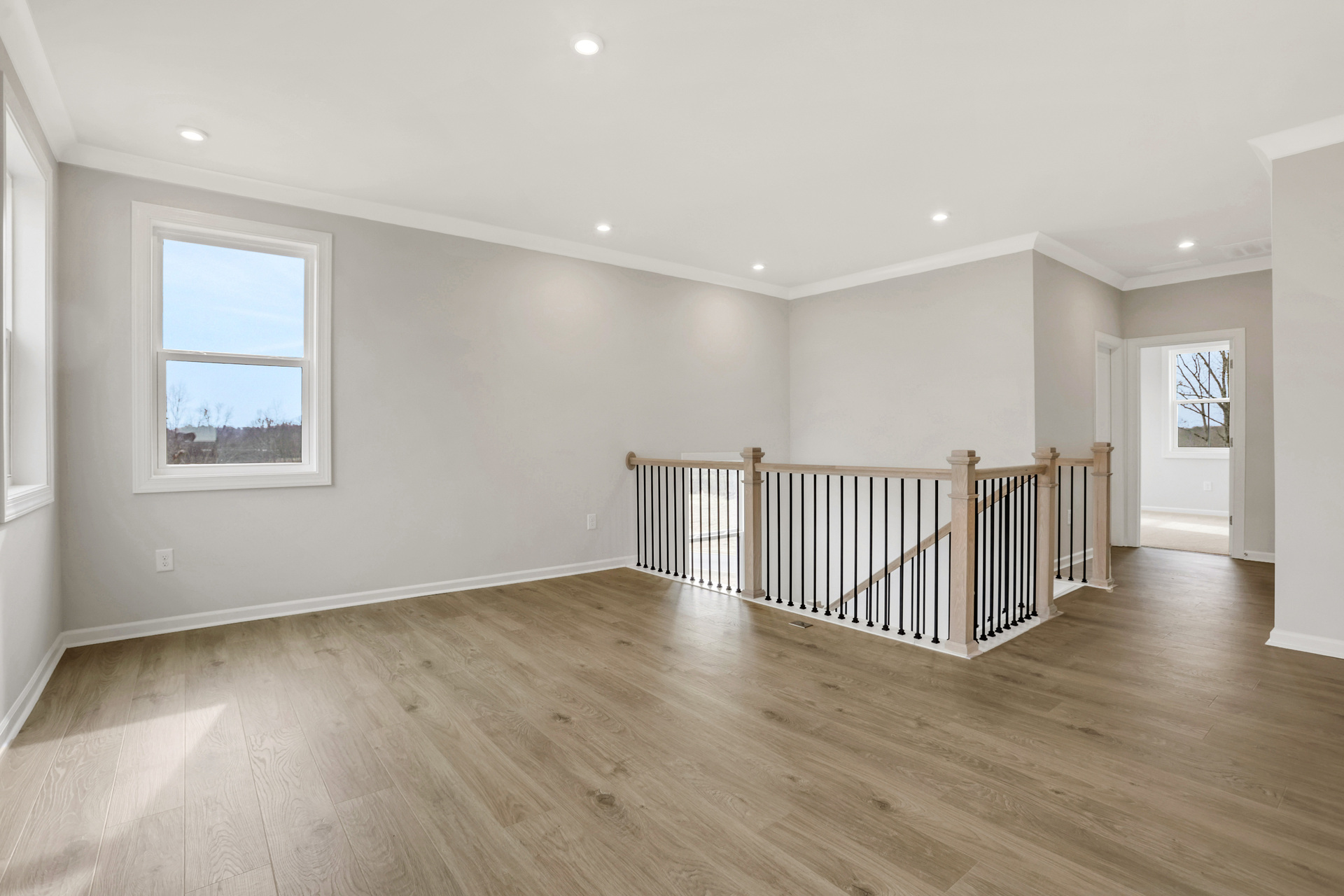 loft with hard-surface flooring and windows