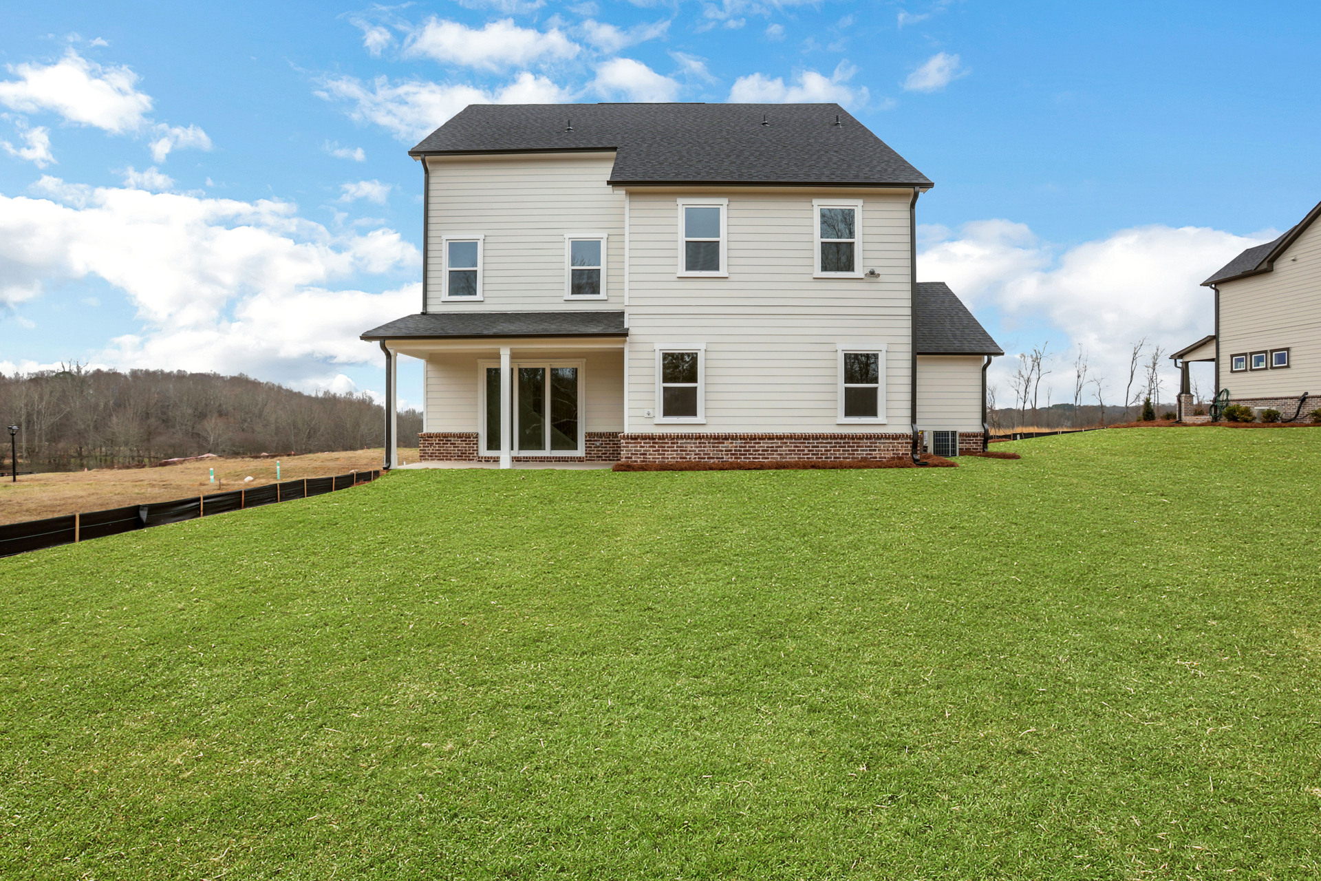 back of 2-story home with covered patio