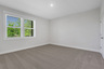 secondary bedroom on the 1st floor with carpet and windows